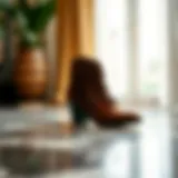 Elegant pair of fringe ankle boots on a marble surface