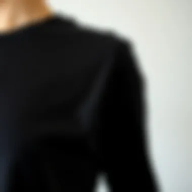 Close-up of fabric texture of a black slim fit t-shirt