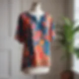 A vibrant floral tunic top displayed on a mannequin in a bright room