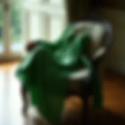 Elegant green nightgown draping gracefully on a vintage chair