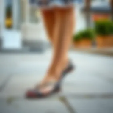 Stylish black flat sandals paired with a summer dress.